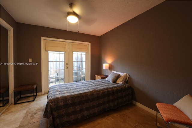 bedroom with access to exterior, french doors, and ceiling fan