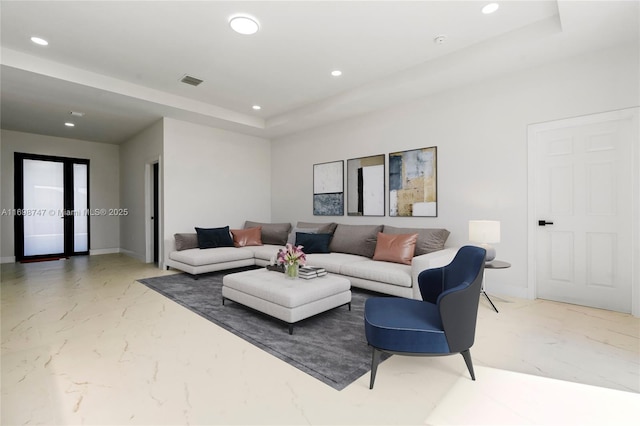 living room with a tray ceiling