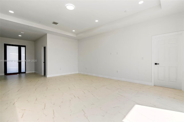 empty room featuring a tray ceiling