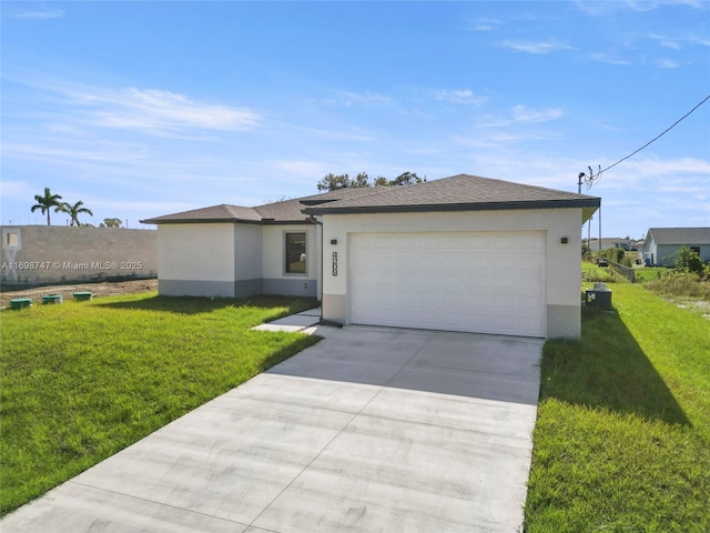 view of front of home with a front yard and a garage