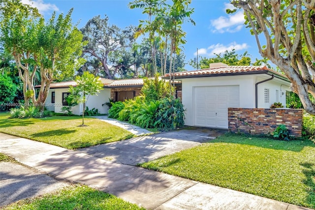 view of front of house with a garage and a front yard