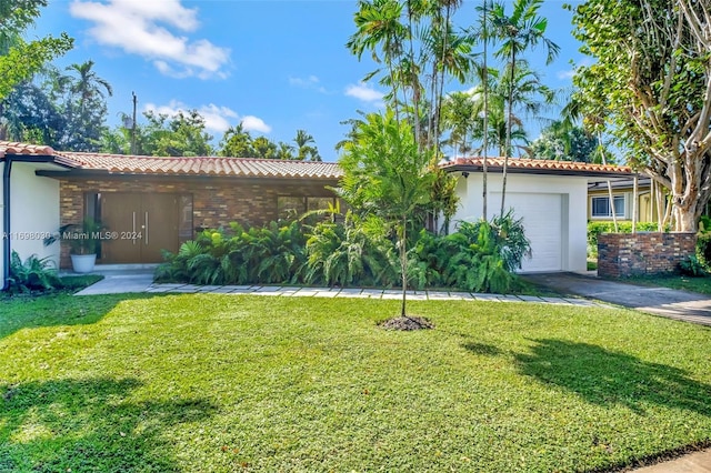 view of front of property featuring a front yard and a garage