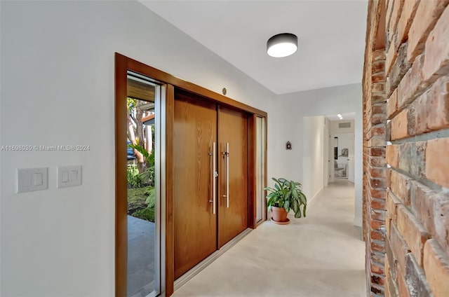 hallway with light colored carpet