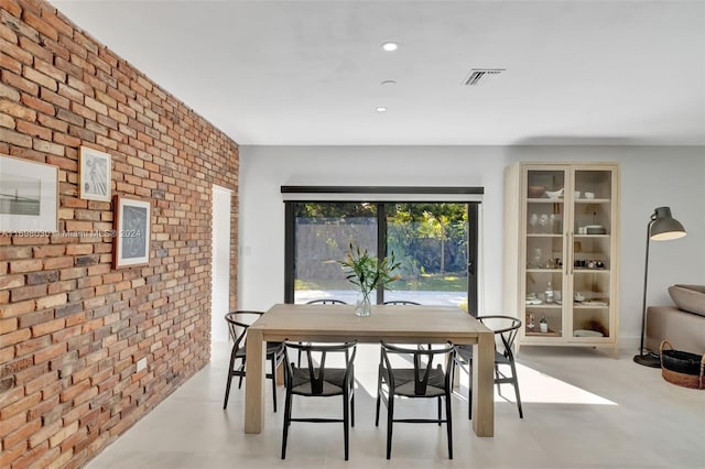 dining space with brick wall