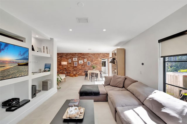 living room featuring built in features and brick wall