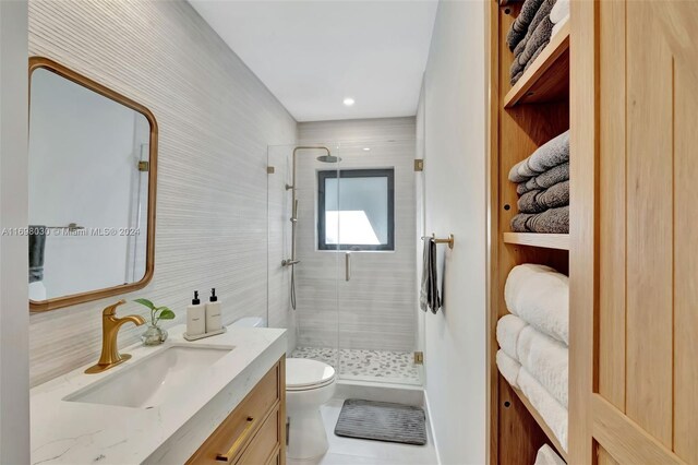 bathroom featuring vanity, tasteful backsplash, toilet, and walk in shower