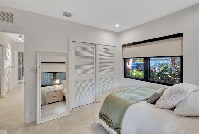 bedroom with a closet and light colored carpet