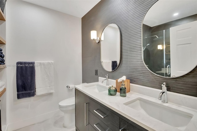 bathroom featuring vanity, an enclosed shower, and toilet