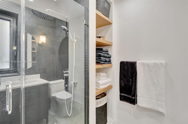 bathroom with a shower with door and toilet