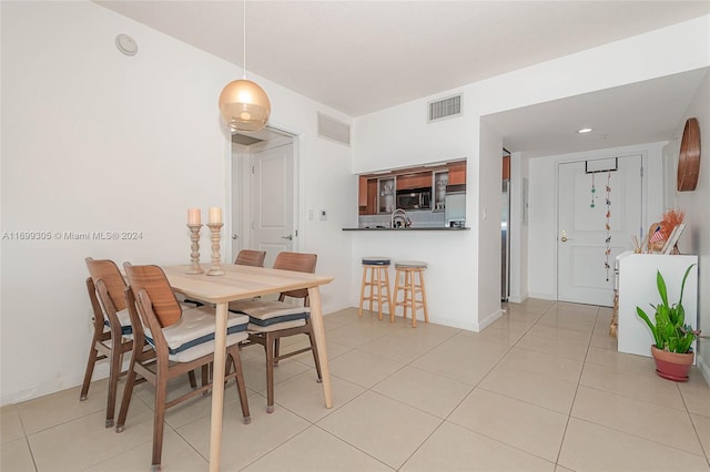 dining area featuring light tile patterned floors