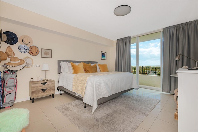 bedroom featuring access to exterior and light tile patterned floors