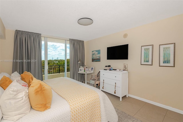 bedroom with light tile patterned flooring and access to outside