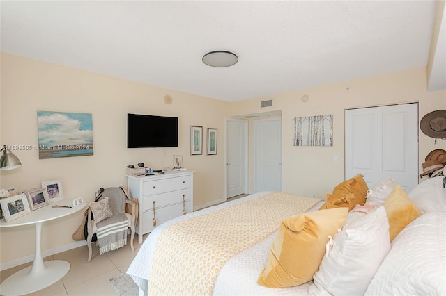 bedroom featuring a closet and light tile patterned floors