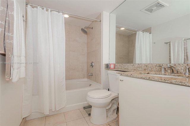 full bathroom featuring tile patterned flooring, vanity, toilet, and shower / tub combo