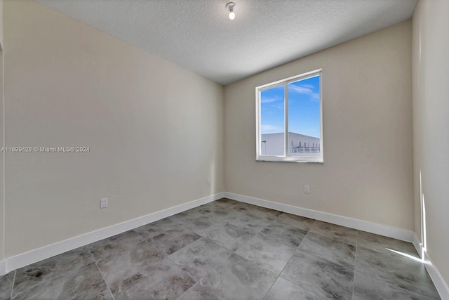 spare room with a textured ceiling