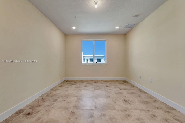 spare room featuring a textured ceiling