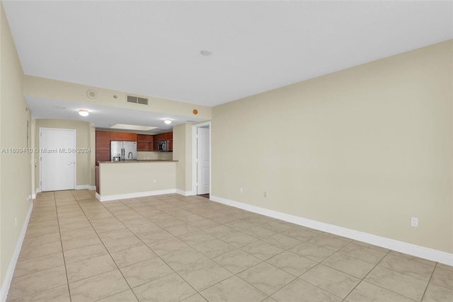 unfurnished living room with light tile patterned flooring