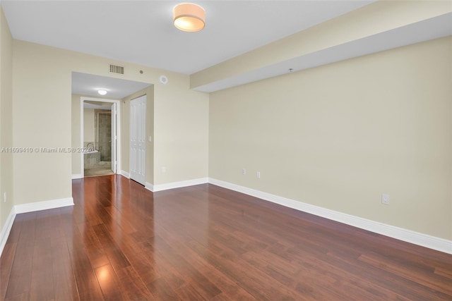 unfurnished room featuring dark hardwood / wood-style floors