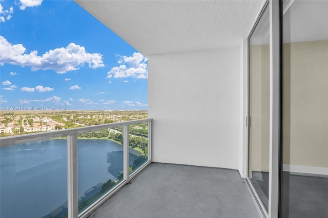 balcony featuring a water view