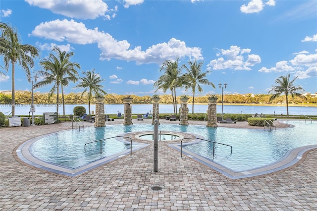 view of pool featuring a community hot tub and a water view