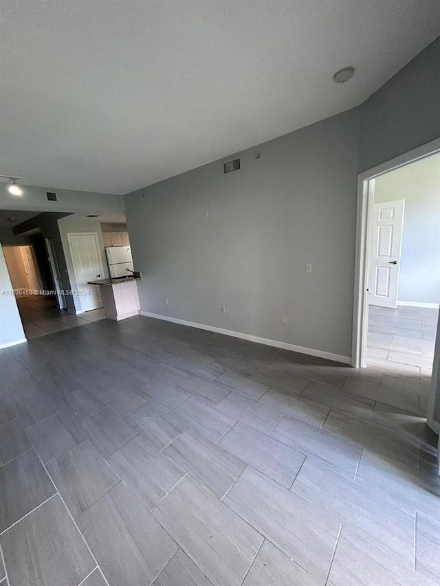 unfurnished living room with a textured ceiling