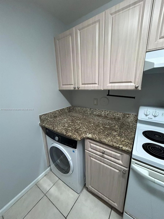 washroom with light tile patterned flooring and washer / dryer