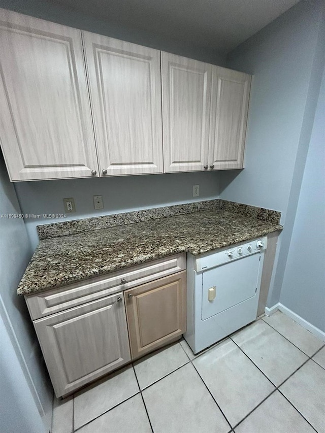 washroom featuring light tile patterned flooring and washer / clothes dryer