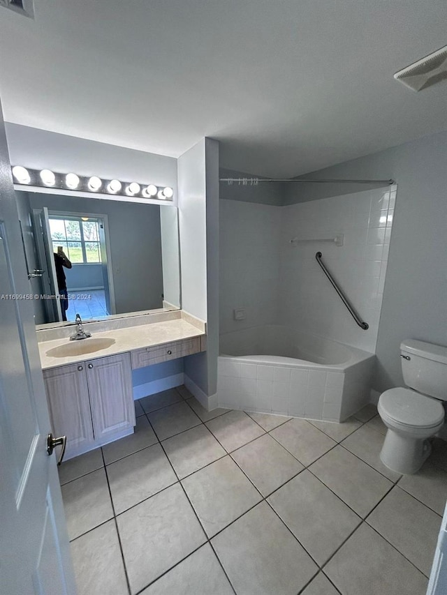 full bathroom featuring toilet, tile patterned flooring, vanity, and tiled shower / bath