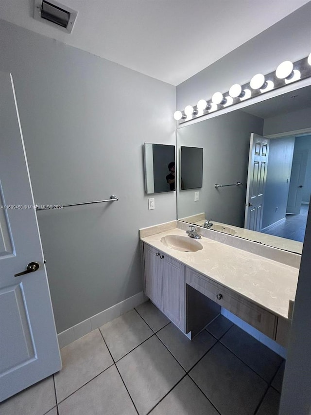 bathroom with tile patterned flooring and vanity