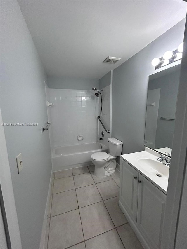 full bathroom featuring tile patterned floors, tiled shower / bath combo, toilet, and vanity