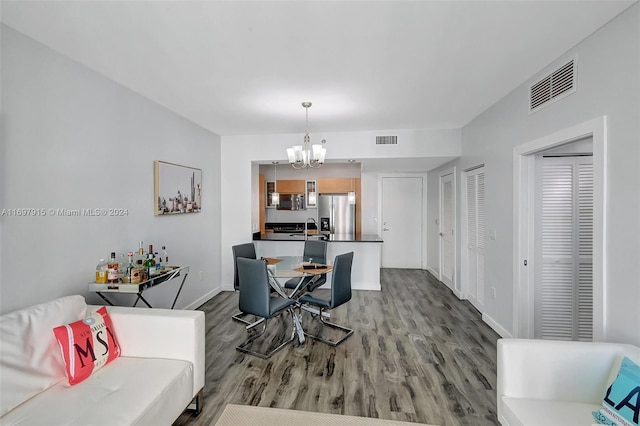 dining room featuring hardwood / wood-style floors, a notable chandelier, and sink