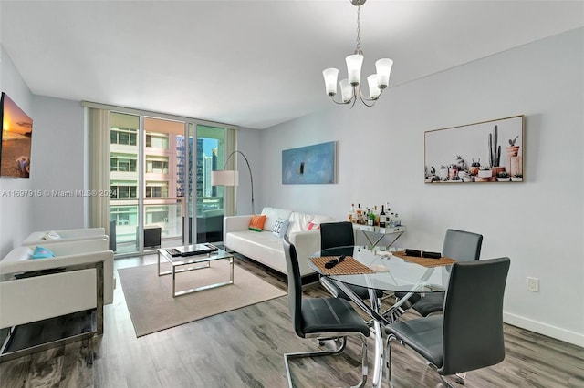 dining room with hardwood / wood-style flooring and a chandelier