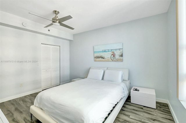 bedroom with wood-type flooring, a closet, and ceiling fan