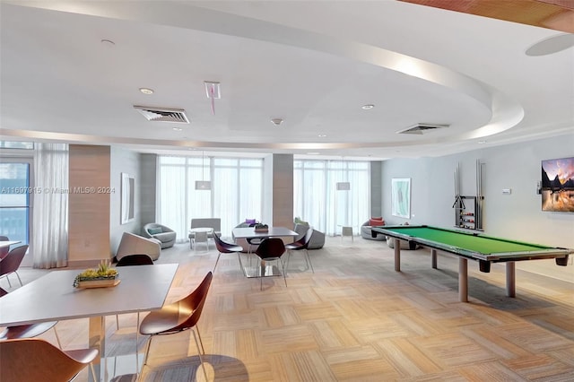 playroom featuring light parquet floors, a raised ceiling, plenty of natural light, and pool table