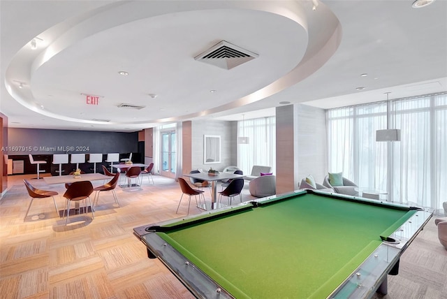 rec room featuring a tray ceiling, plenty of natural light, and billiards