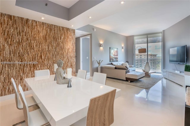 dining space featuring wooden walls