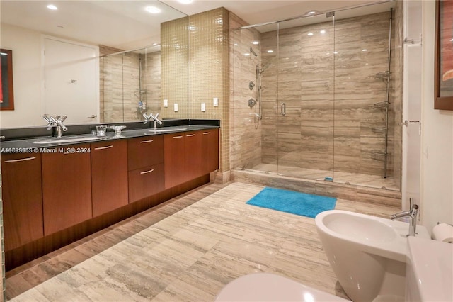 bathroom with an enclosed shower, vanity, and a bidet