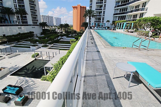 view of swimming pool featuring a patio area