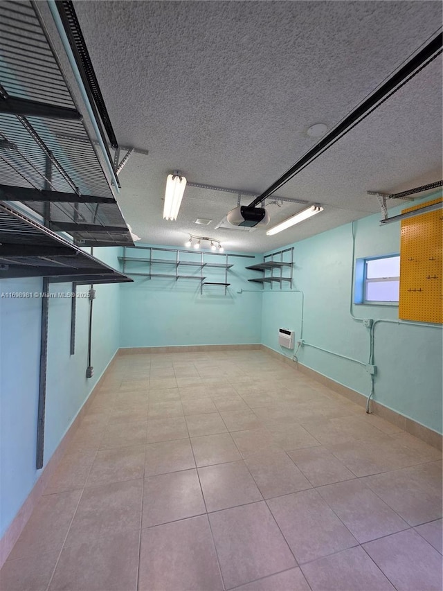 basement featuring light tile patterned flooring and a textured ceiling