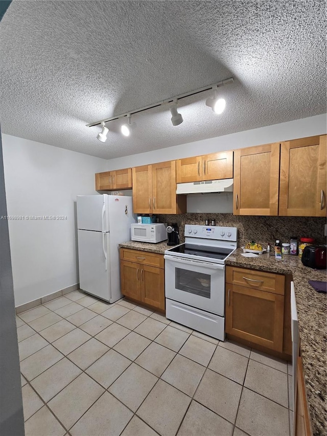 kitchen with rail lighting, backsplash, a textured ceiling, white appliances, and light tile patterned floors