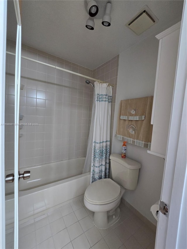 bathroom featuring tile patterned flooring, shower / bathtub combination with curtain, and toilet