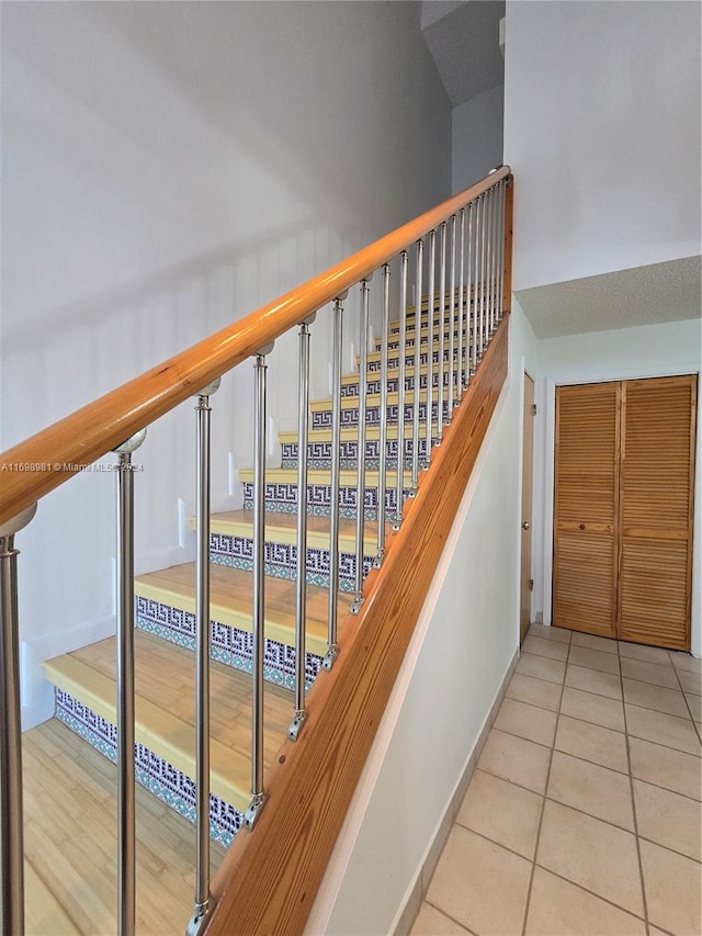 staircase with tile patterned floors