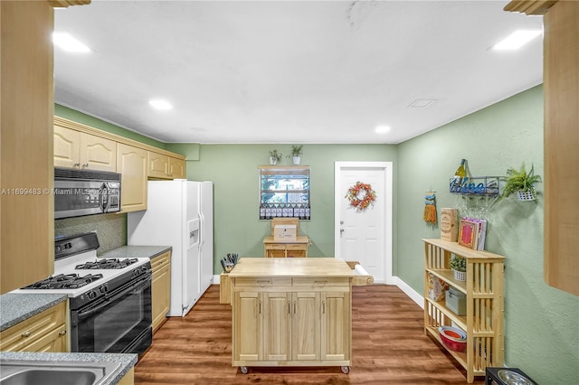 kitchen featuring a kitchen island, white appliances, dark wood-type flooring, and light brown cabinetry