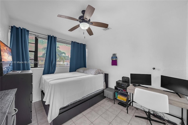 tiled bedroom featuring ceiling fan