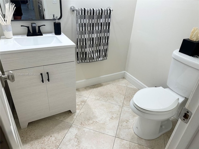 bathroom featuring tile patterned flooring, vanity, and toilet