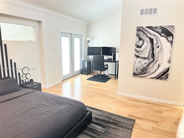 bedroom featuring hardwood / wood-style floors, french doors, and ornamental molding