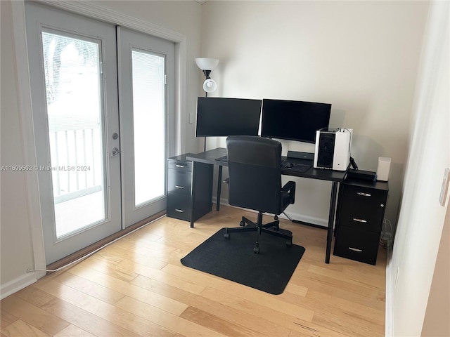 office area with light hardwood / wood-style flooring and french doors