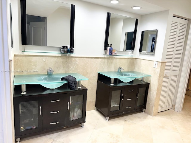 bathroom with tile patterned floors, vanity, and tile walls