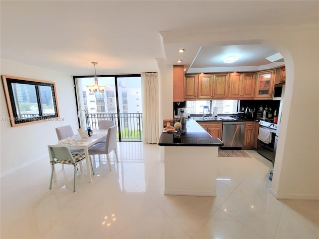 kitchen with pendant lighting, light tile patterned floors, appliances with stainless steel finishes, and a chandelier