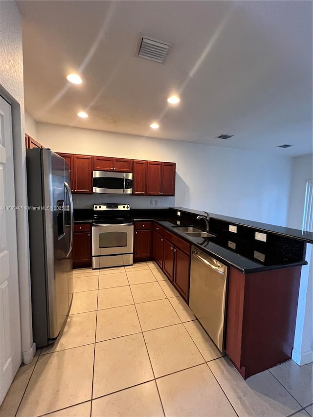 kitchen featuring appliances with stainless steel finishes, sink, and light tile patterned floors